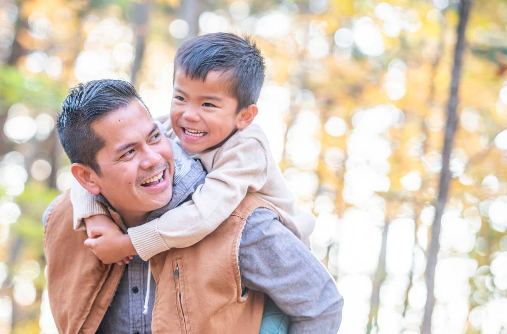 Dad giving son a piggy back ride