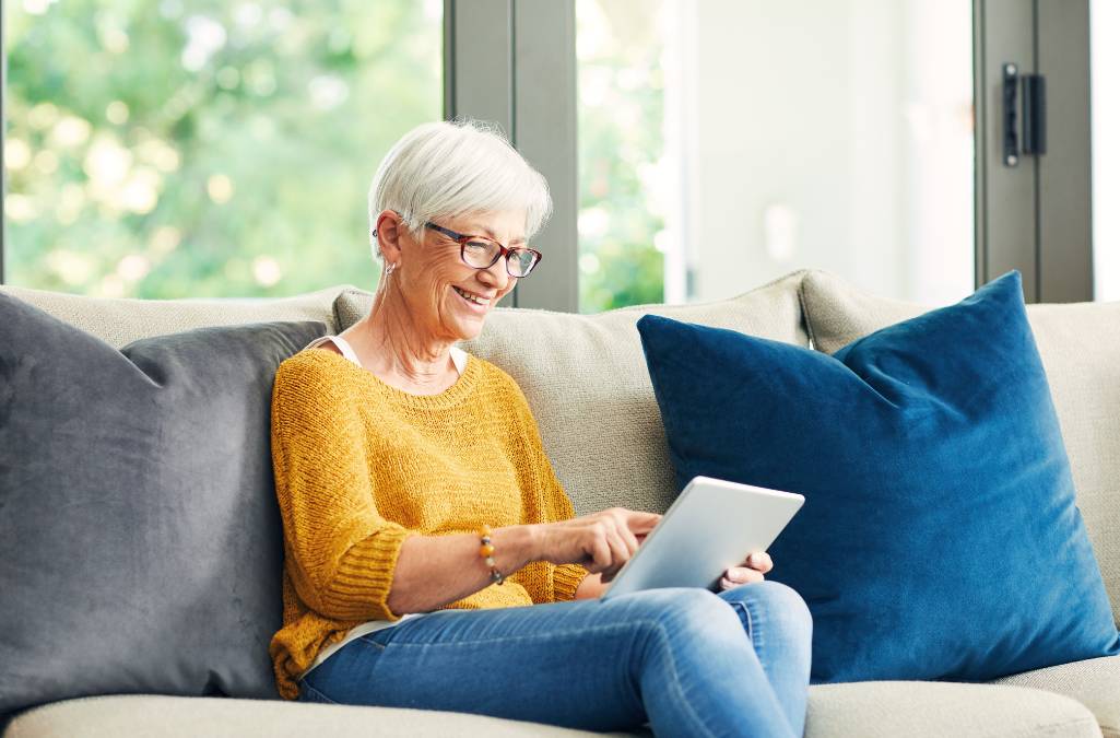 Older woman reading tablet device