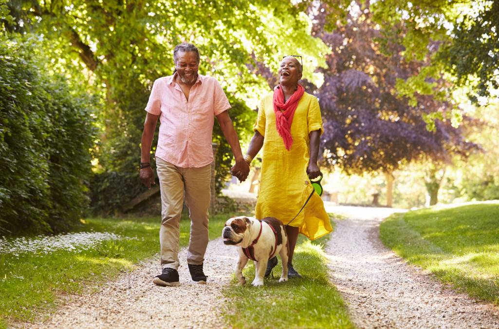 Older couple walking their dog