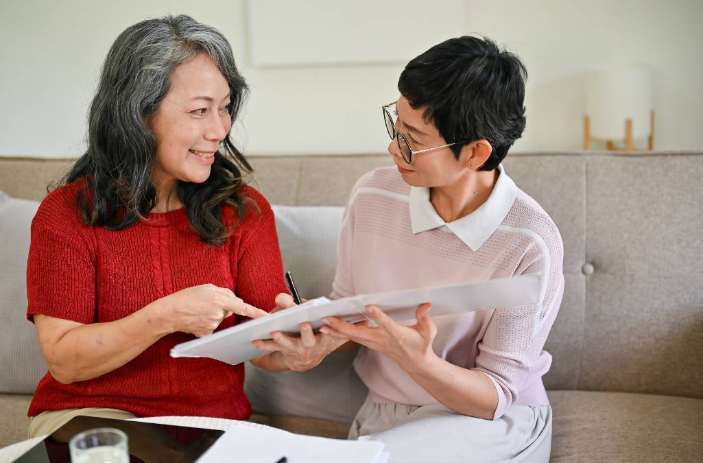 2 Woman reviewing documents while sitting on couch