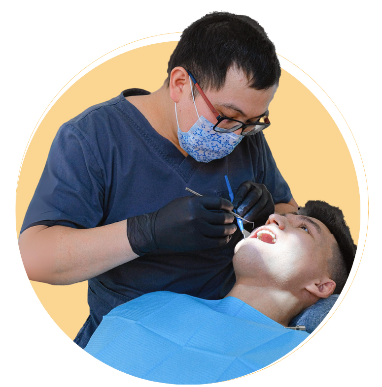 Dentist cleaning patients teeth